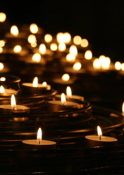 Lots of burning tea lights in the dark.